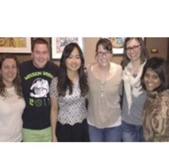 6 people smile at the camera
                  