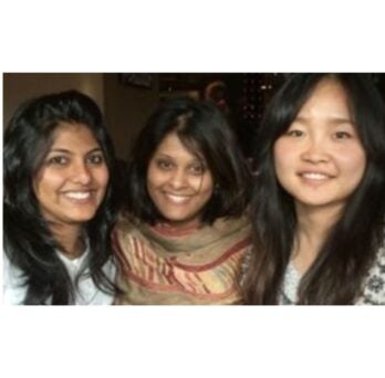 3 women smile at the camera
                  