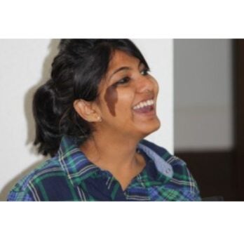 a women in profile smiling
                  