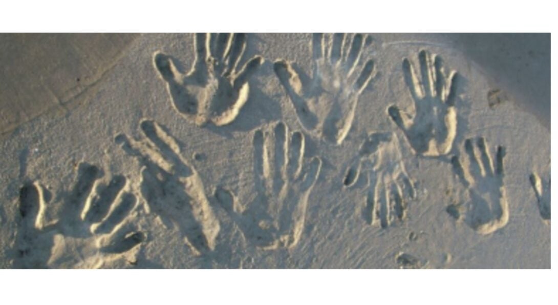 hand imprints in the sand