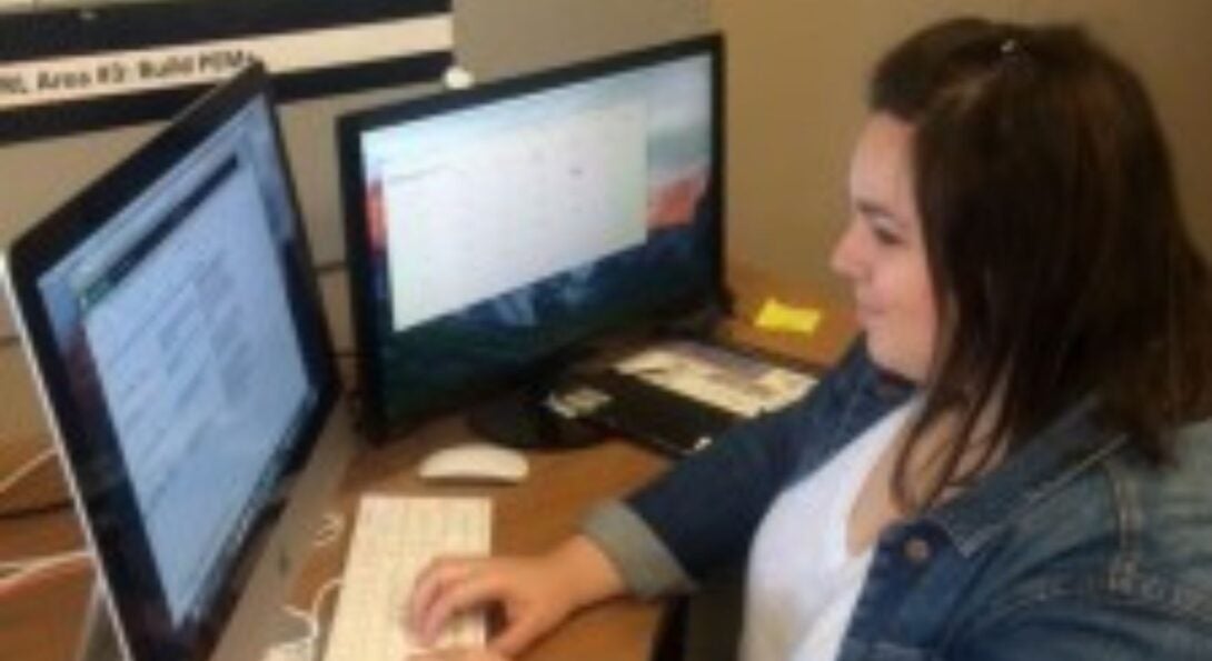 Christina Sidorowych sitting at a desk using a computer
