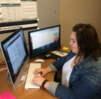 Christina Sidorowych sitting at a desk using a computer
                  