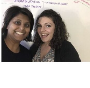 Mary Khetani and Jessica Jarvis pose in front of a whiteboard
                  
