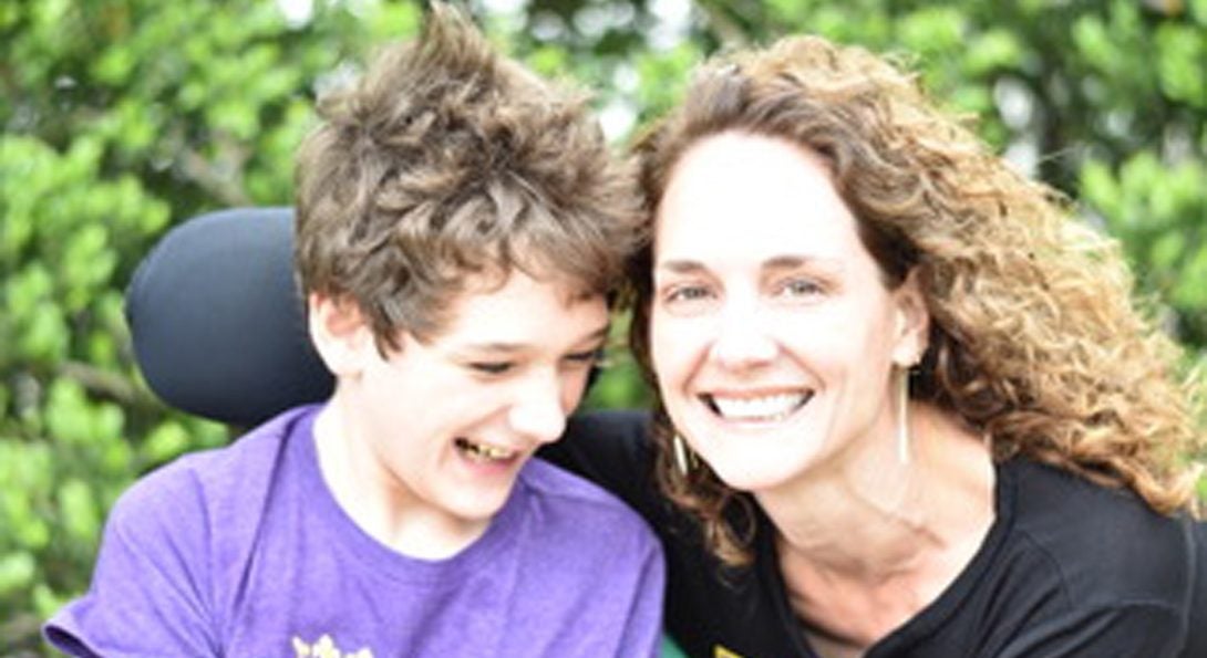 a woman and a child smiling at the camera