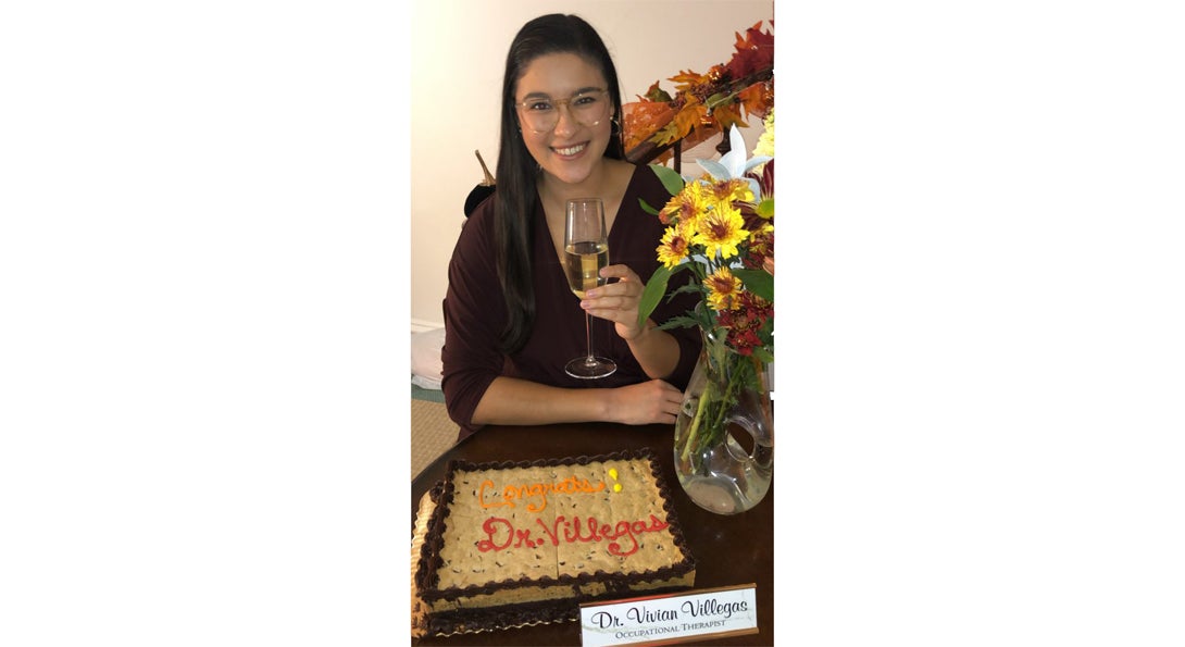 a woman with a glass of wine and cake